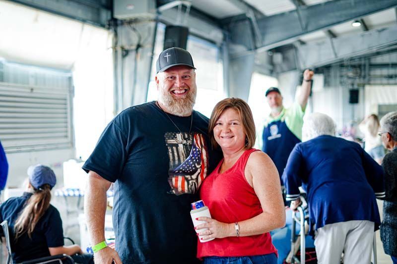 A man and a woman are posing for a picture in a room.