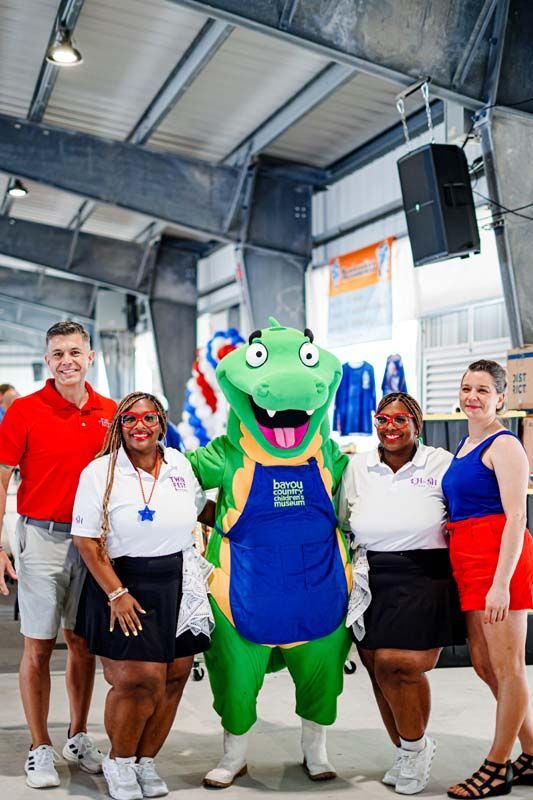 A group of people are posing for a picture with a mascot.