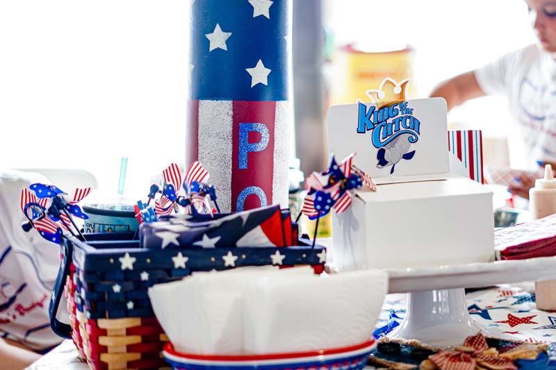 A table decorated for a fourth of july party with a cake on it.