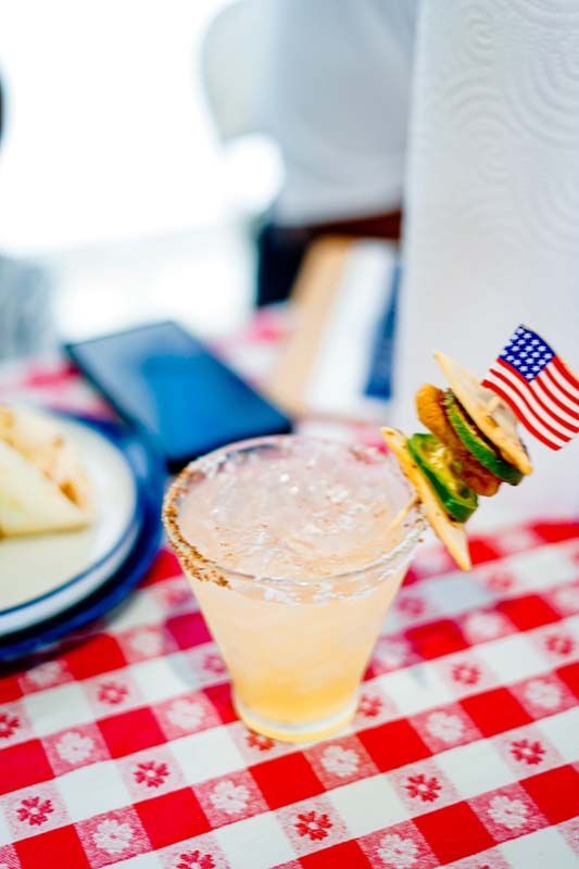 A drink with an american flag sticking out of it