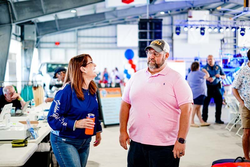 A man and a woman are standing next to each other in a room.