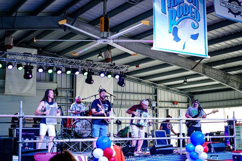 A group of men are playing instruments on a stage in a boxing ring.