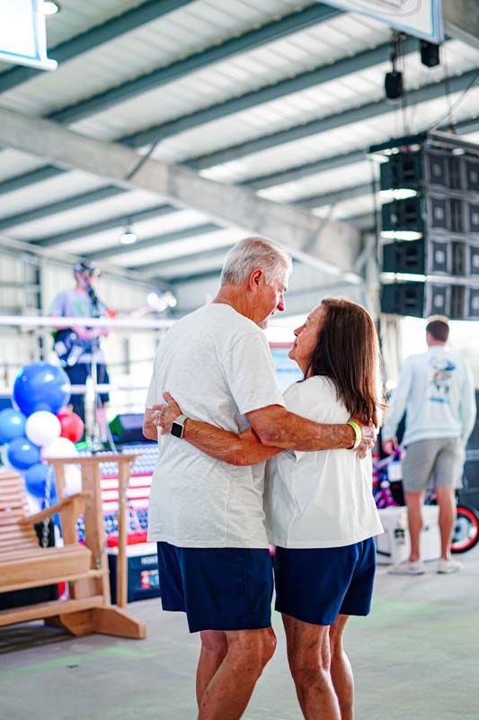 A man and a woman are dancing together in a room.