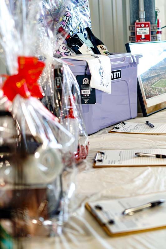 A table with a purple bin and a clipboard on it.