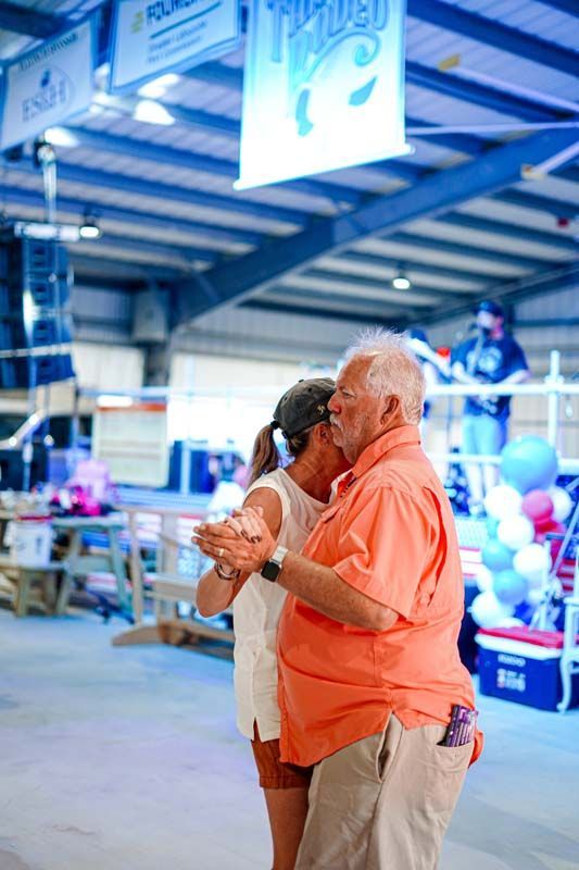 A man and a woman are dancing together in a room.