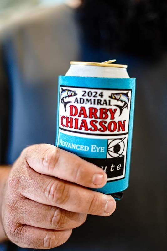 A person is holding a can of darby chiasson beer