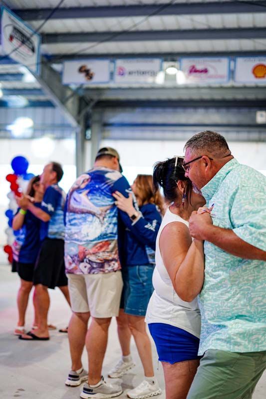 A group of people are dancing together in a room.