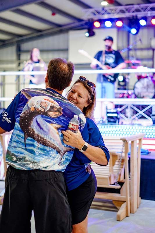 A man and a woman are dancing in front of a band.