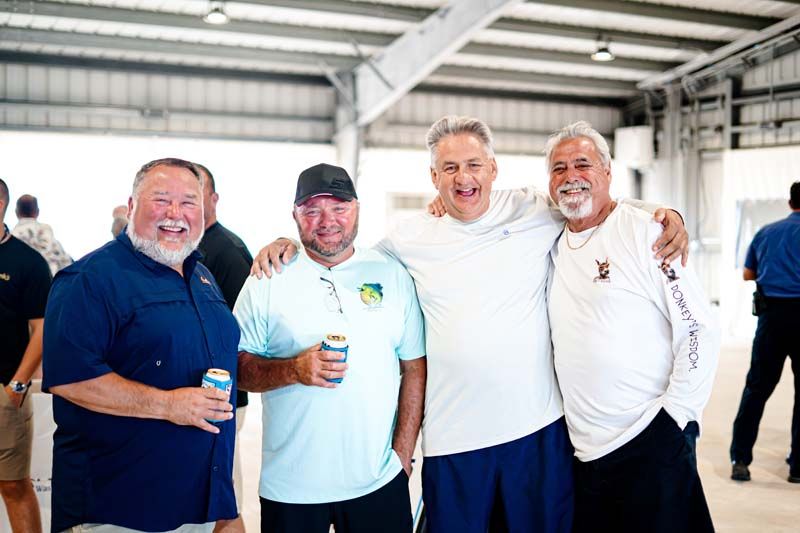 A group of men are posing for a picture in a building.