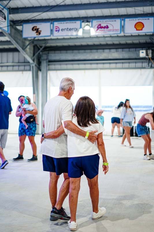 A man and a woman are dancing together in a room.
