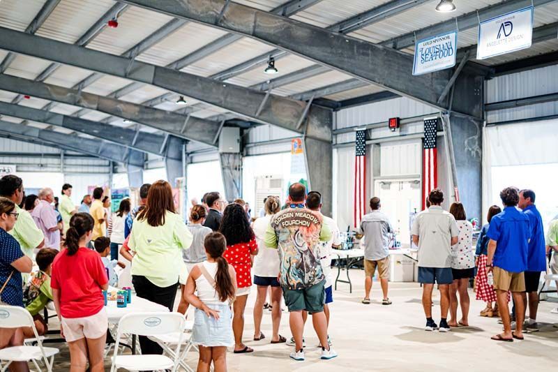 A large group of people are standing in a room.