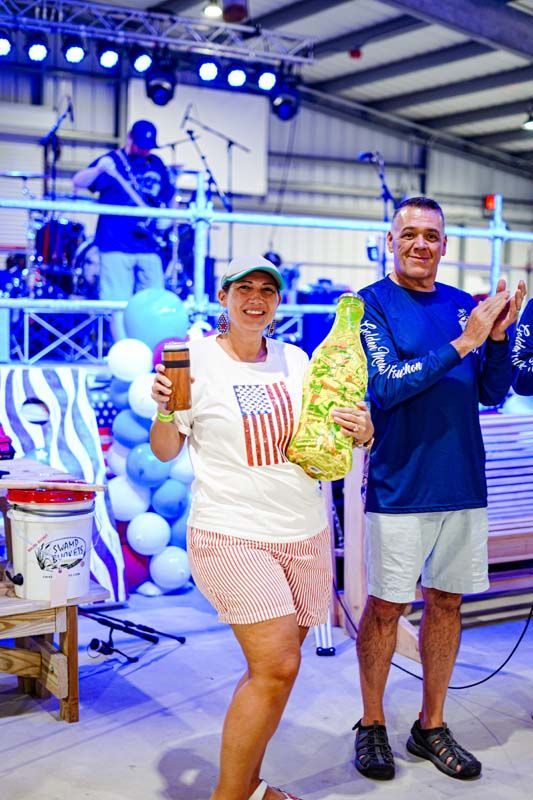 A man and a woman are standing next to each other on a stage.