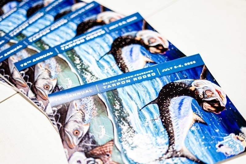 A stack of brochures with a picture of fish on them