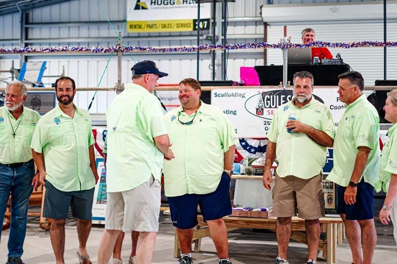 A group of men are standing next to each other in a room.