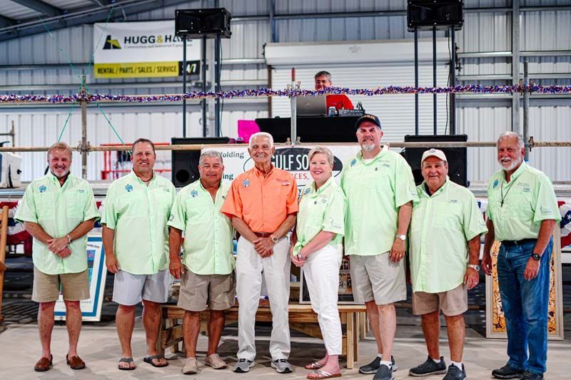 A group of people standing next to each other in a room.