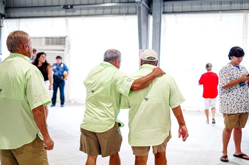 A group of men are standing next to each other in a room.