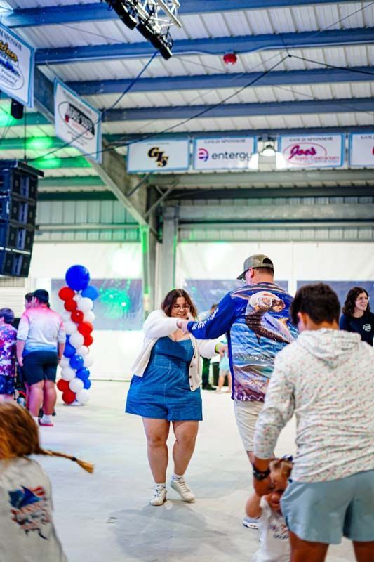 A group of people are dancing on a ice rink.
