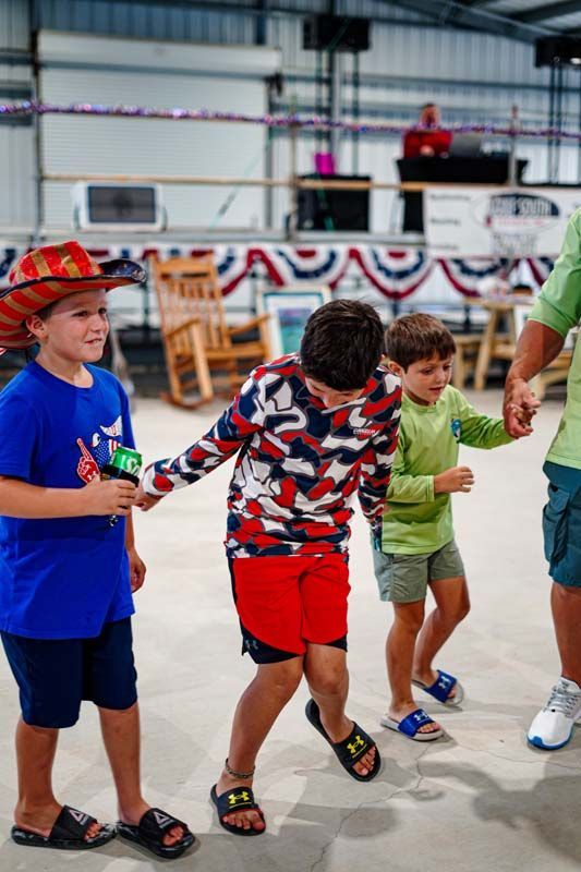 A group of young boys are holding hands and dancing in a room.