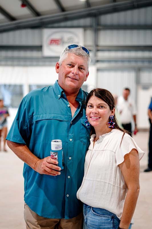 A man and a woman are posing for a picture in a building.