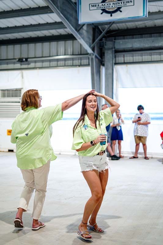 Two women are dancing together in a warehouse.