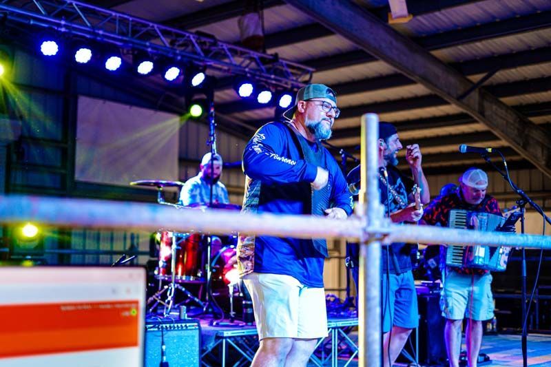 A man is standing in a boxing ring on a stage.