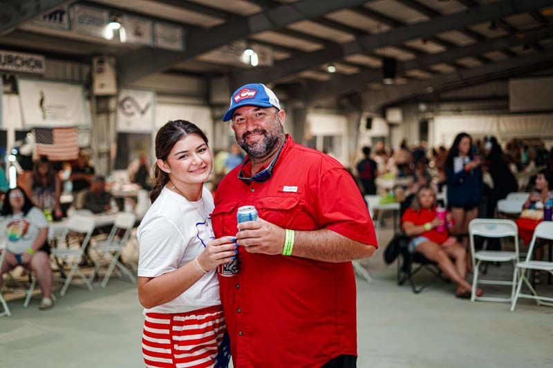 A man and a girl are posing for a picture in a room.