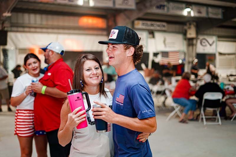 A man and a woman are standing next to each other in a room.