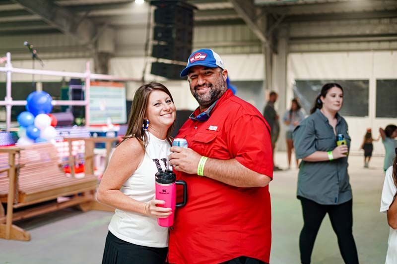 A man and a woman are standing next to each other in a room.