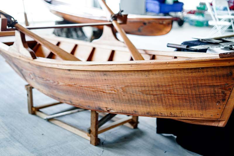A wooden boat is sitting on a wooden stand