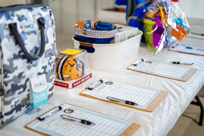 A table with a bunch of clipboards and pens on it.