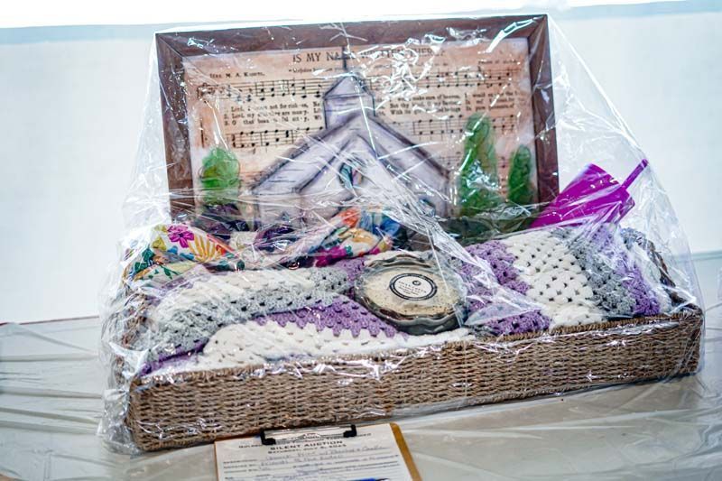 A basket with a picture of a church on it is sitting on a table.