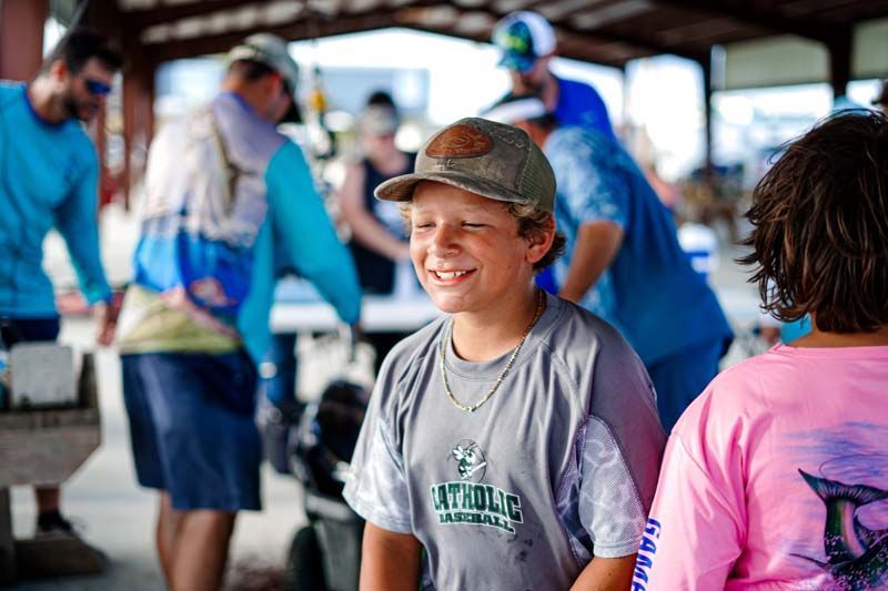 A young boy is sitting in front of a group of people.