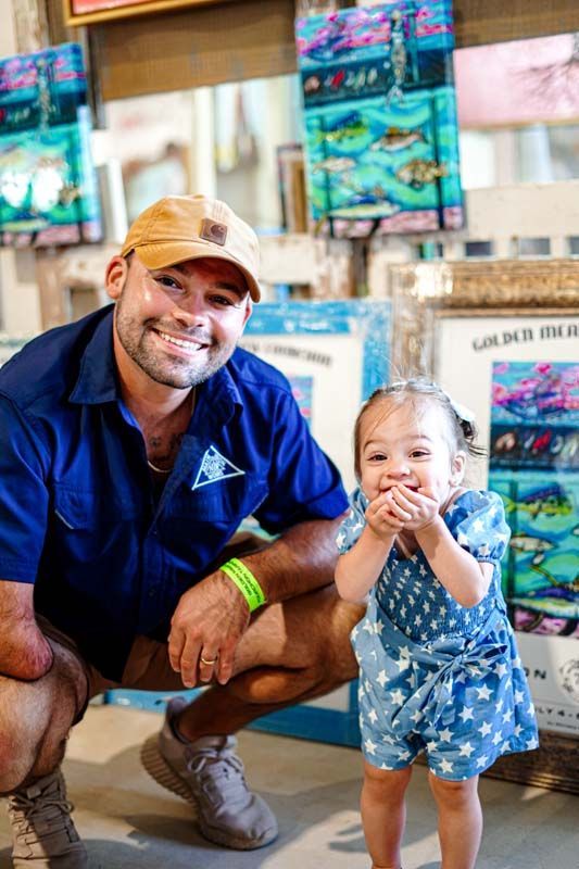 A man and a little girl are posing for a picture.
