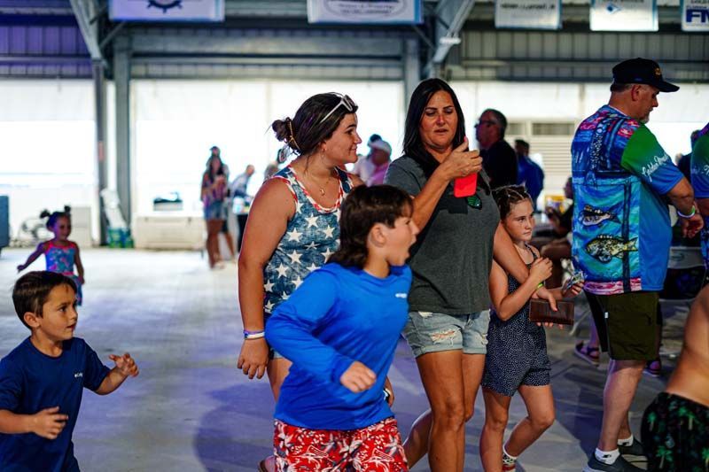 A group of people are dancing in a room.