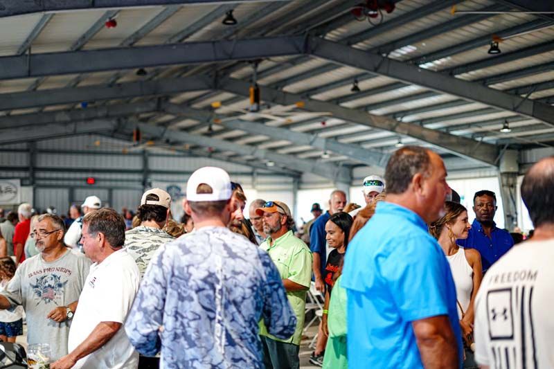 A large group of people are standing in a building.