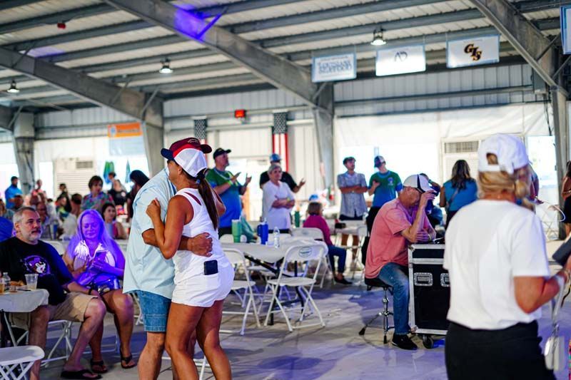 A group of people are dancing in a large room.