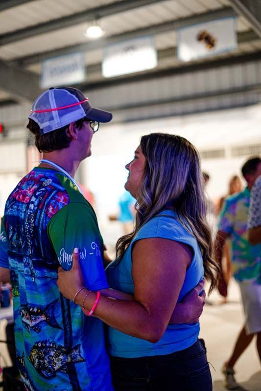 A man and a woman are dancing together in a room.