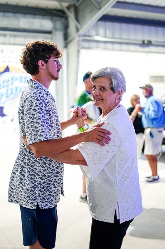 A man and a woman are dancing together in a room.