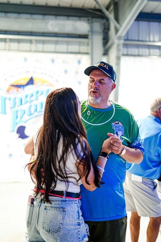 A man and a woman are dancing together in a room.