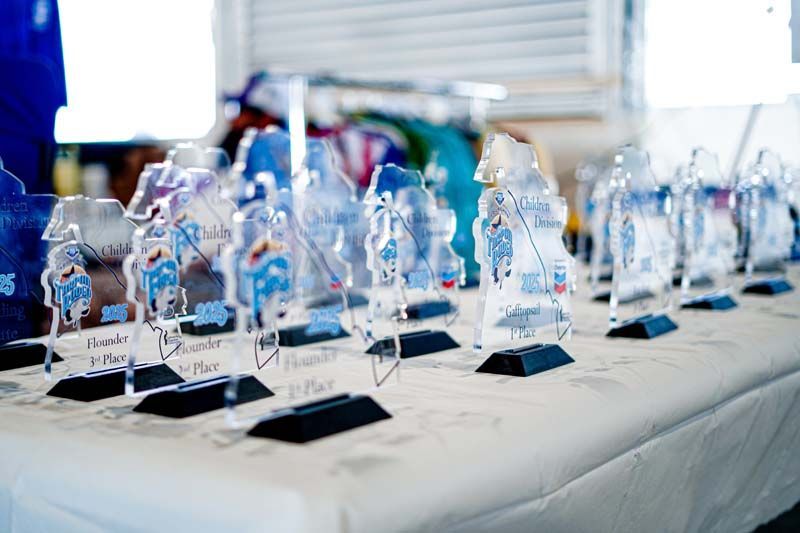 A row of trophies sitting on top of a table.