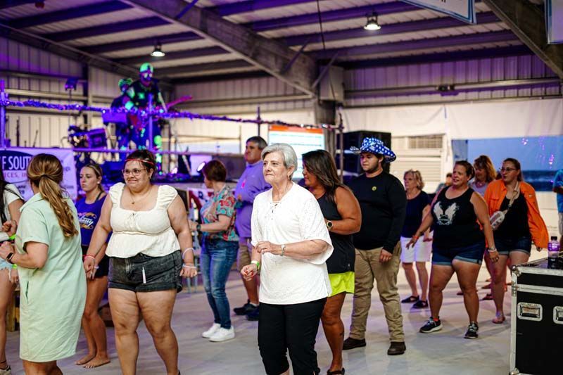 A group of people are dancing in a room.