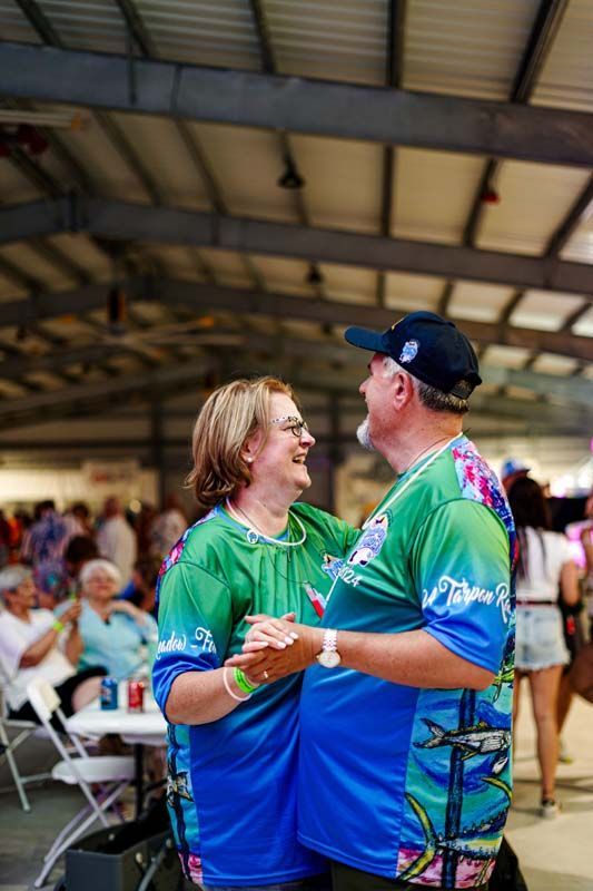 A man and a woman are dancing together in a room.