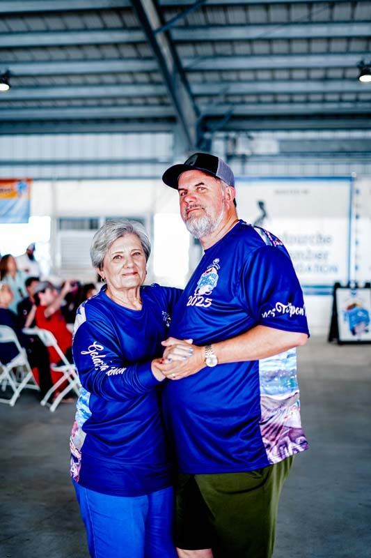 A man and a woman are dancing together in a room.