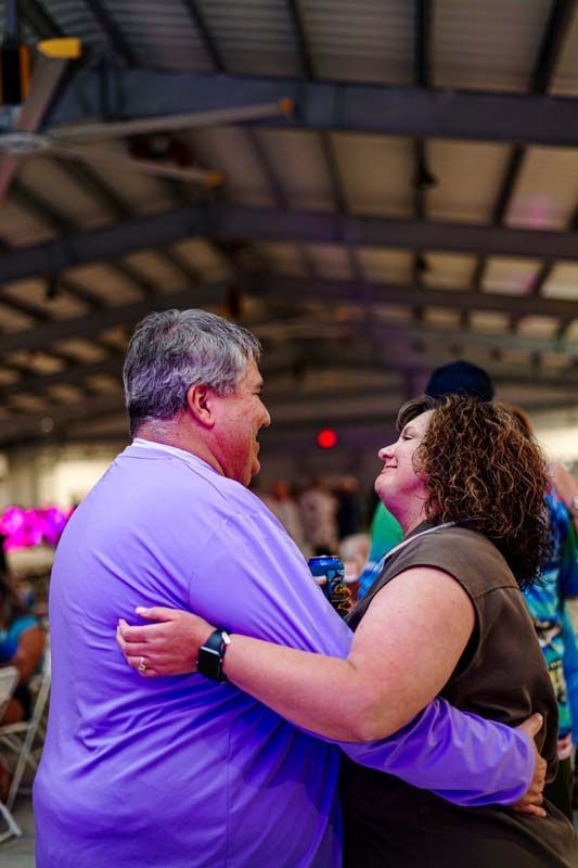 A man and a woman are dancing together in a room.