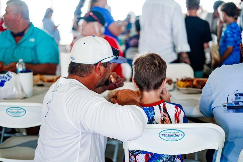 A man and a boy are sitting at a table in a restaurant.
