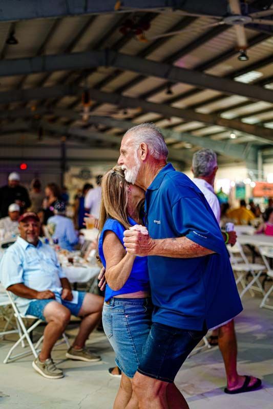 A man and a woman are dancing together in a crowded room.