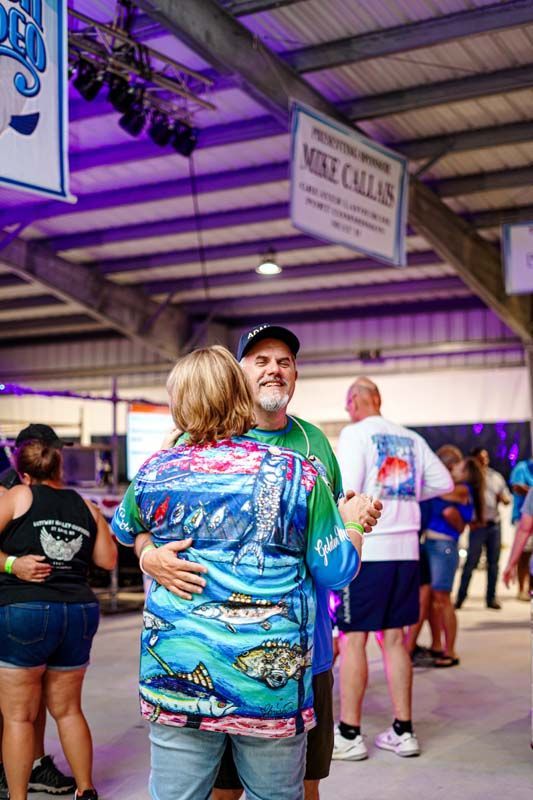 A man and a woman are dancing together at a party.