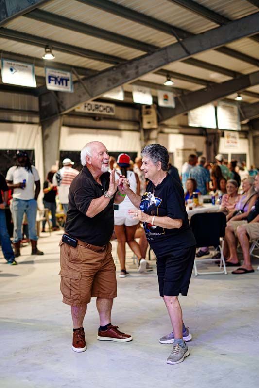 A man and a woman are dancing together in a room.