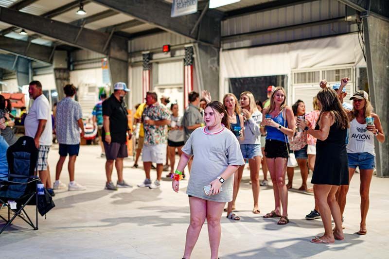 A group of people are standing in a room.