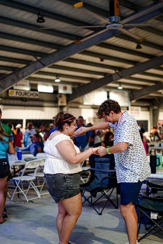 A man and a woman are dancing in a crowded room.